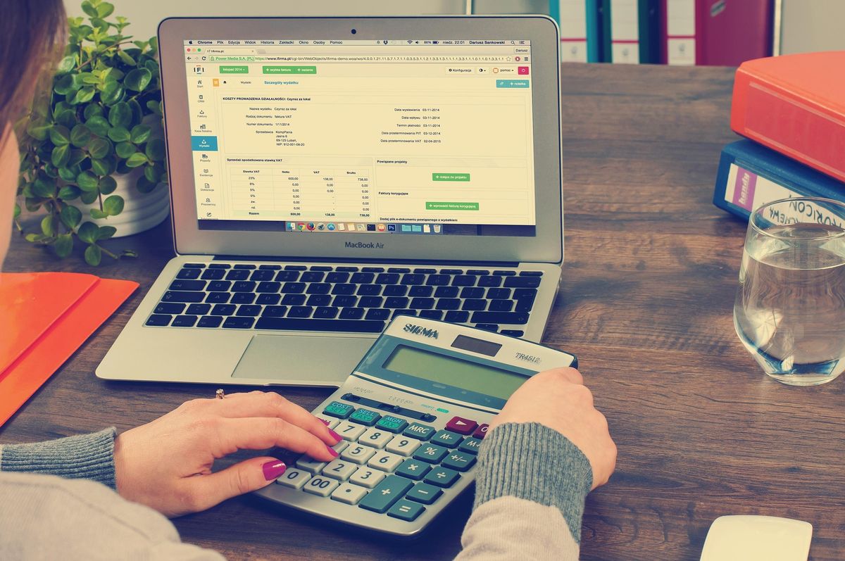 Accountant working on a laptop with a calculator